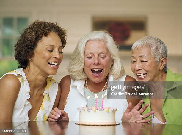 three mature women celebrating birthday - older woman birthday stock pictures, royalty-free photos & images