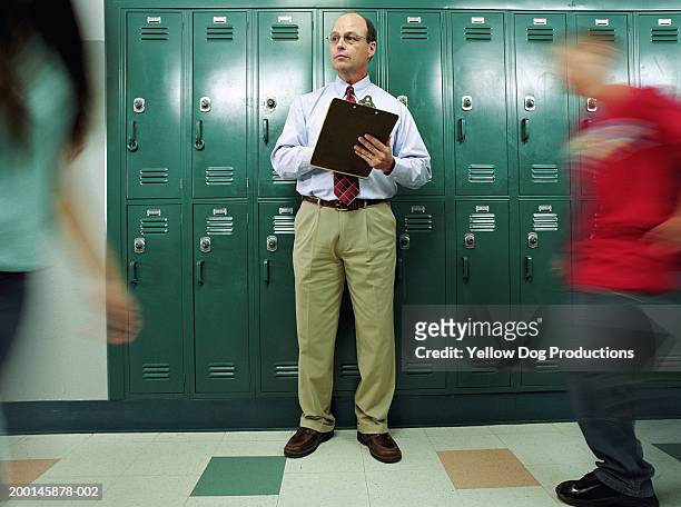 man in school hallway with clipboard - public scrutiny stock pictures, royalty-free photos & images