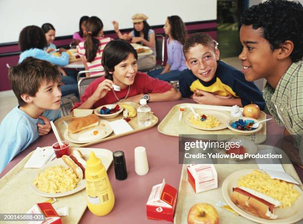 group of kids (12-14) having lunch in cafeteria - school lunch stock pictures, royalty-free photos & images