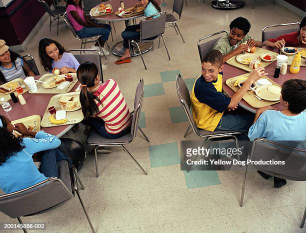 group of kids (12-14) smiling in cafeteria, elevated view - cliqueimages stock pictures, royalty-free photos & images