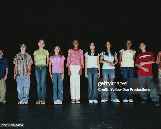 group of kids (12-14) in row on stage, smiling, portrait - girl stage stock-fotos und bilder