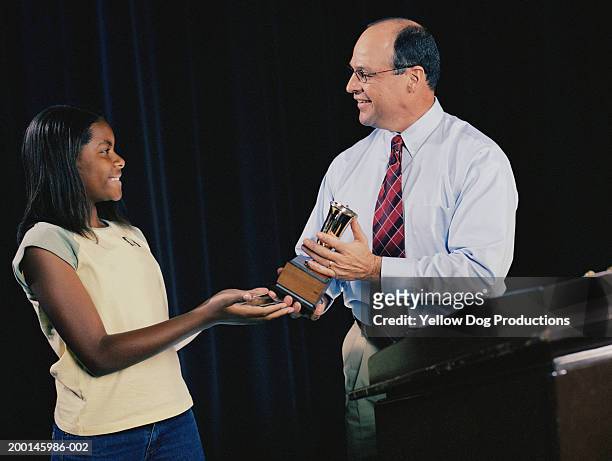 man giving trophy to teenage girl  (12-14) at podium - teen awards bildbanksfoton och bilder