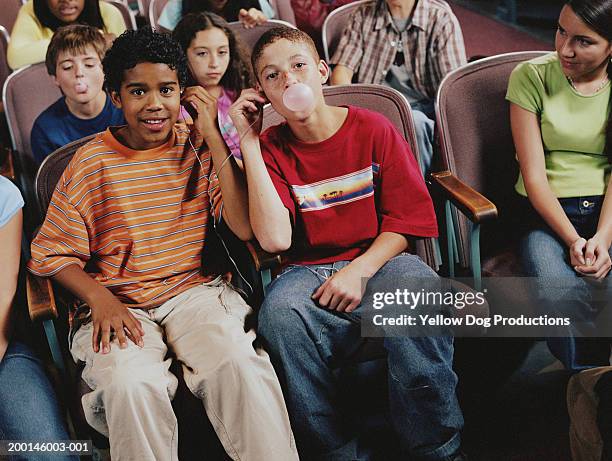 group of kids (12-14) in room, boys with headphones blowing bubble - leitor de cd portátil imagens e fotografias de stock