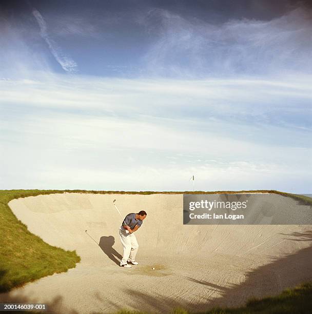 male golfer playing in sand trap - golf bunker 個照片及圖片檔