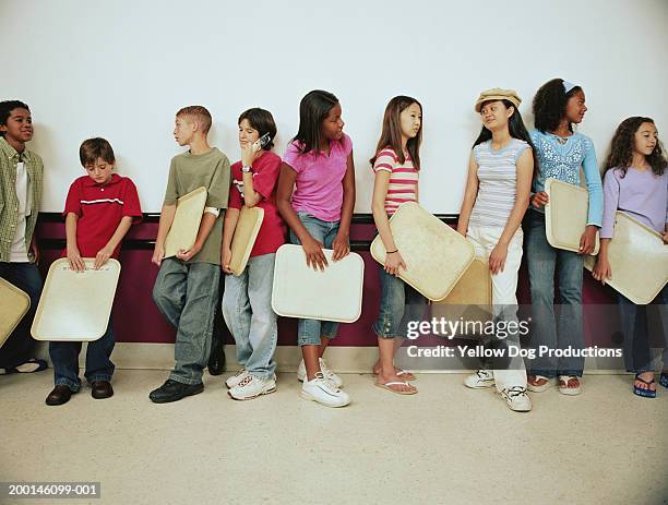 group of kids (12-14) holding trays on lunch line - cantina imagens e fotografias de stock