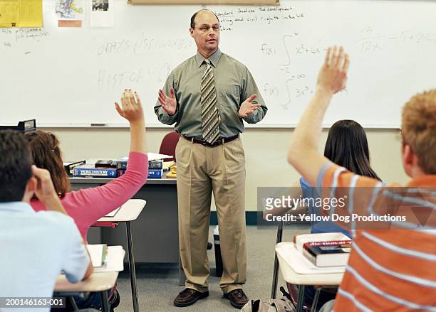teacher talking to students (16-18) in classroom - man standing and gesturing stock pictures, royalty-free photos & images
