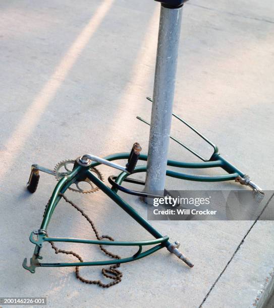 bike frame around iron pole on sidewalk - rob crocker stock pictures, royalty-free photos & images