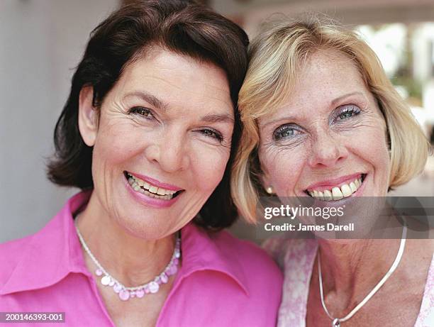 two mature women smiling, portrait, close-up - james blondes stockfoto's en -beelden