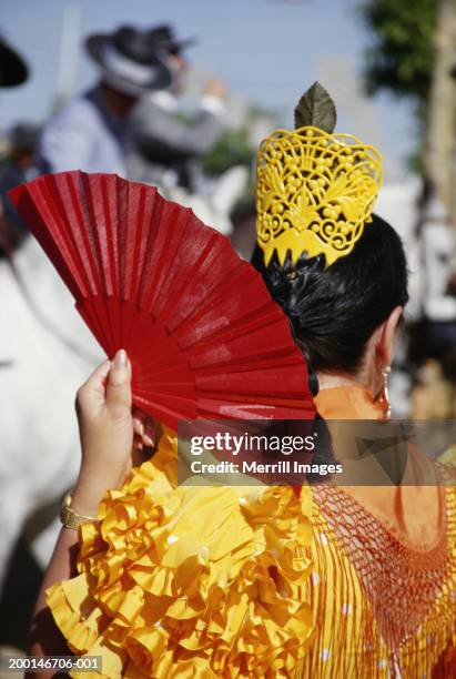 woman flamenco dancing, holding fan, rear view - flamenco shirt stock pictures, royalty-free photos & images