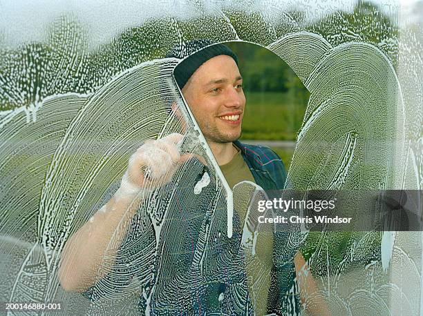man washing window, view through glass - sud side company stock pictures, royalty-free photos & images