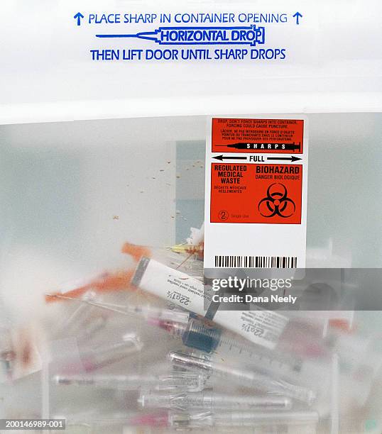 syringes in medical waste container, close-up - behållare för farligt avfall bildbanksfoton och bilder