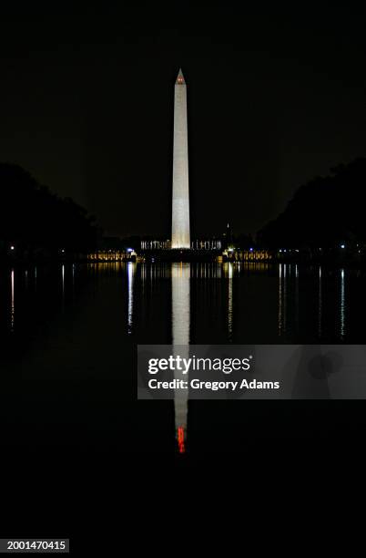 washington monument at night viewed from across the reflecting pool. - washington monument dc stock pictures, royalty-free photos & images