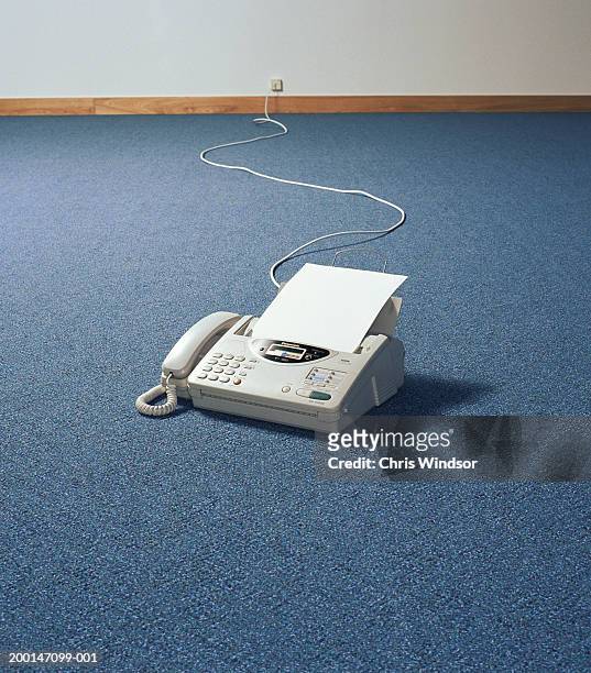 fax machine on floor of empty room - office carpet stock pictures, royalty-free photos & images
