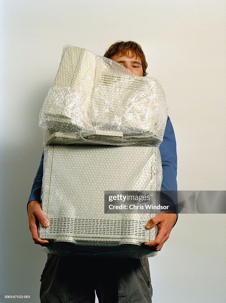 Wrapped Computer Man Carrying Computer Wrapped In Bubble Wrap High-Res Stock Photo ...