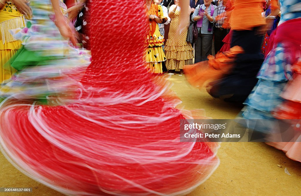 Flamenco dancers spinning, low section (blurred motion)