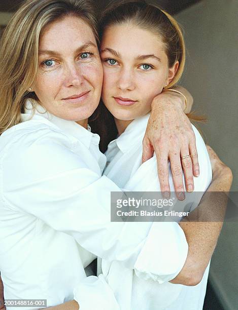 mother with teenage daughter (14-16), portrait - mom daughter white stock-fotos und bilder