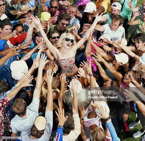 young adults reaching for female celebrity, elevated view - alabanza fotografías e imágenes de stock
