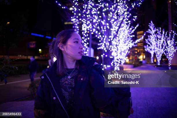 female athlete going back home after training at night - royal blue stock pictures, royalty-free photos & images