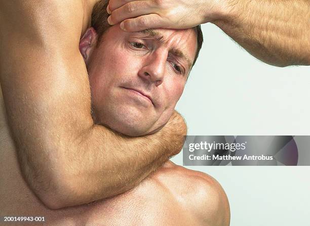 two men wrestling, one in headlock, close-up - prender a cabeça imagens e fotografias de stock