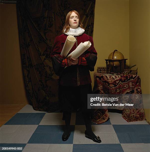 young woman wearing scholar outfit, holding scrolls - stile del xvi secolo foto e immagini stock