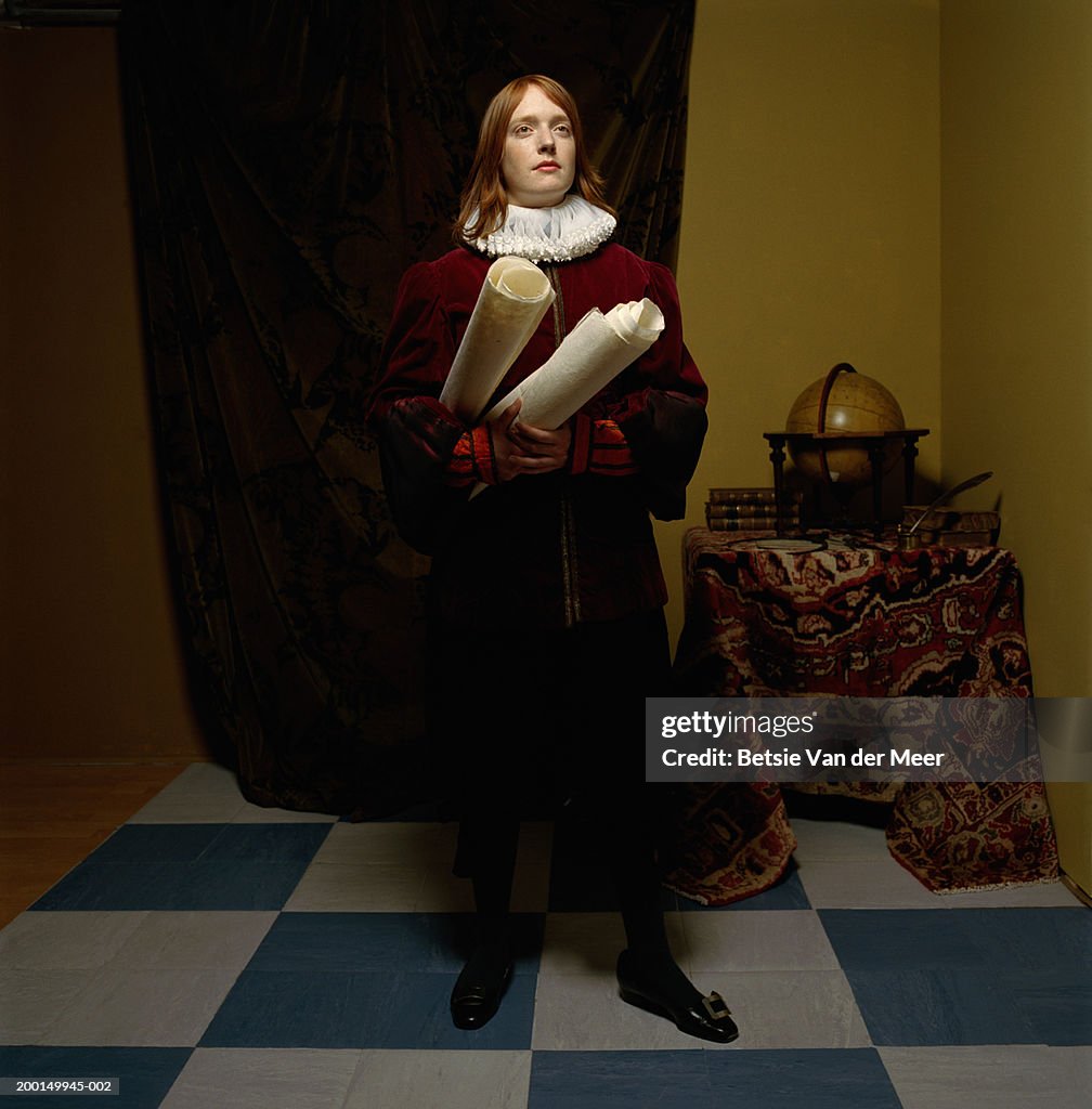 Young woman wearing scholar outfit, holding scrolls