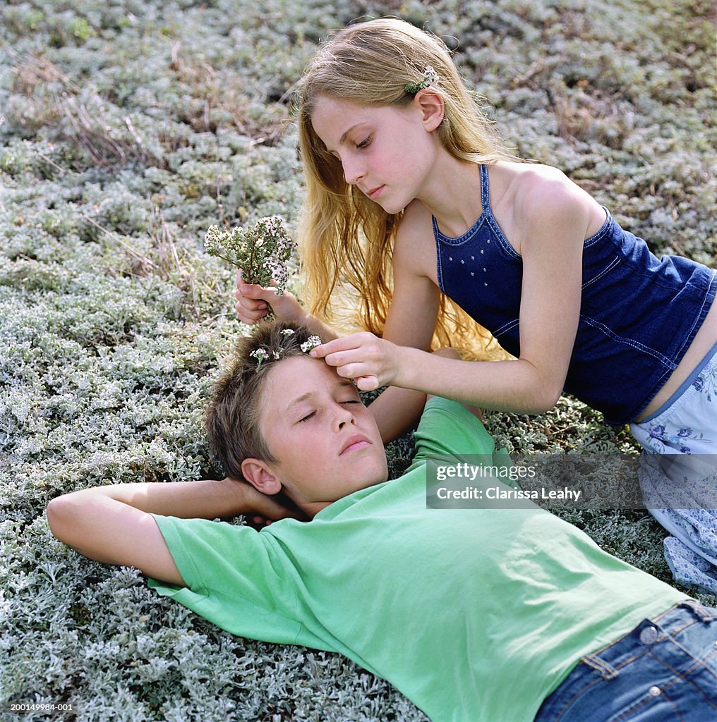 Boy And Girl On Ground Girl Placing Heather In Boys Hair High-Res Stock  Photo - Getty Images