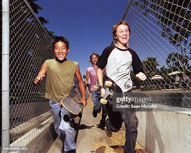 boys (11-15) running with skateboards, portrait - boy skating stock pictures, royalty-free photos & images