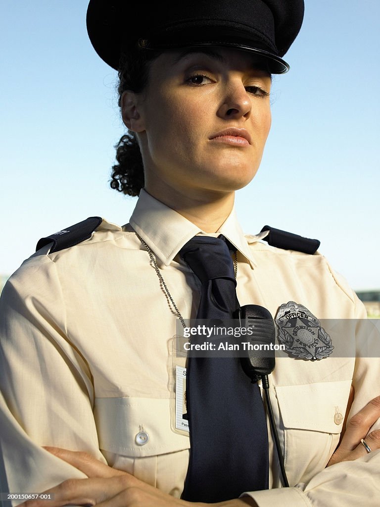 Female prison warden, arms folded, portrait