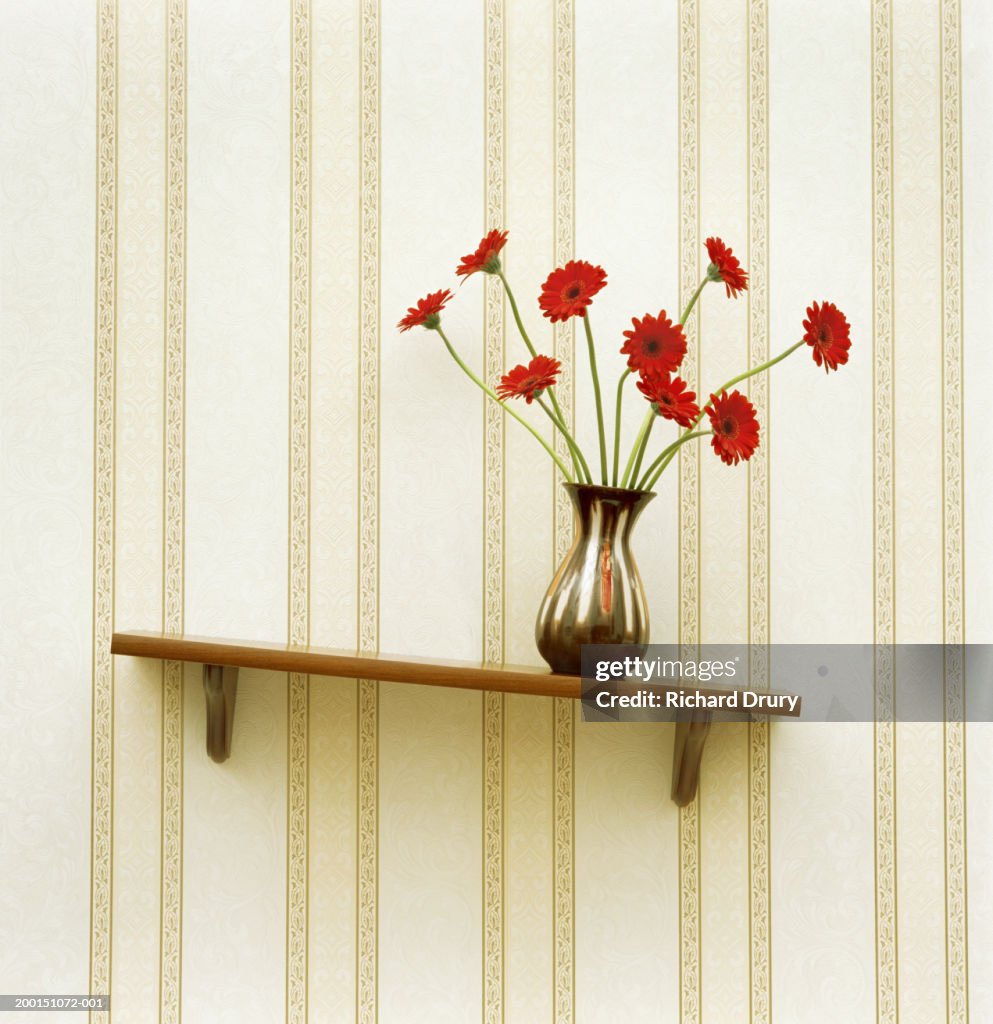 Vase of gerberas on crooked shelf (digital enhancement)