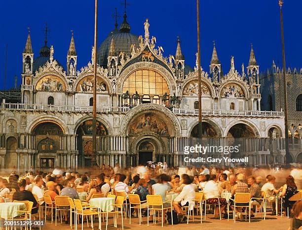 italy, venice, piazza san marco, people seated in front of basilica - basilica di san marco stock-fotos und bilder
