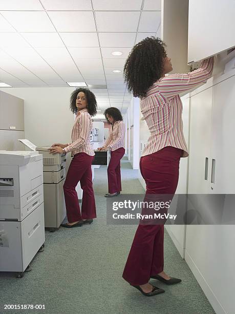 young woman working in office, side view (multiple exposure) - cloning stock-fotos und bilder