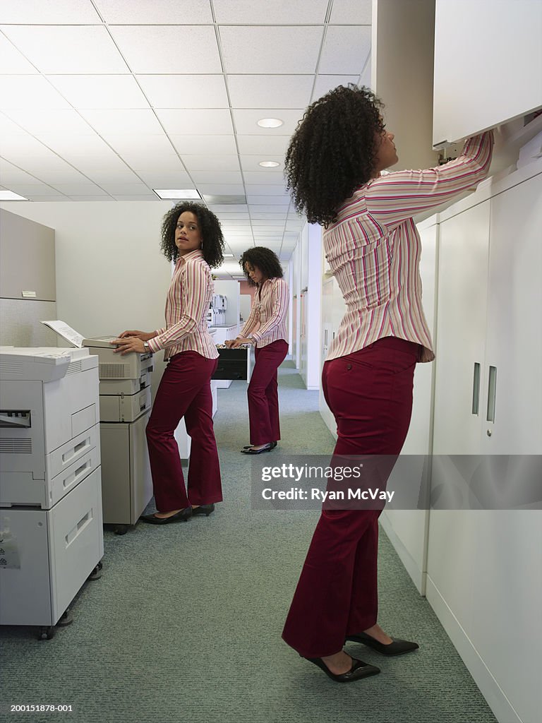 Young woman working in office, side view (Multiple Exposure)