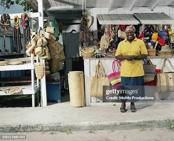 female vendor in front of stand, smiling - owner stand stockfoto's en -beelden