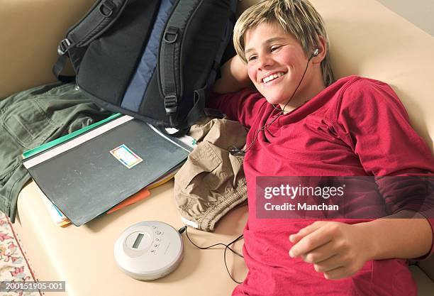 teenage boy (13-15) listening to personal cd player, elevated view - personal compact disc player 個照片及圖片檔