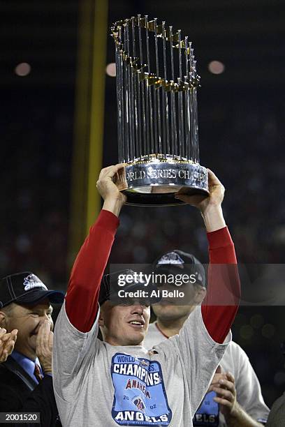 David Eckstein of the Anaheim Angels holds the World Series trophy above his head after the victory over the San Francisco Giants during game seven...