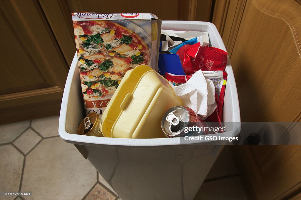 Rubbish bin filled with empty food packaging, close-up