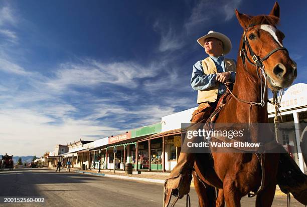 usa, arizona, tombstone, mature cowboy on horseback - tombstone arizona stock pictures, royalty-free photos & images