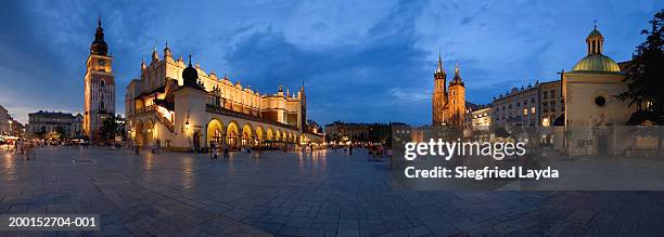 poland, krakow, main market square, dusk - krakow stock pictures, royalty-free photos & images