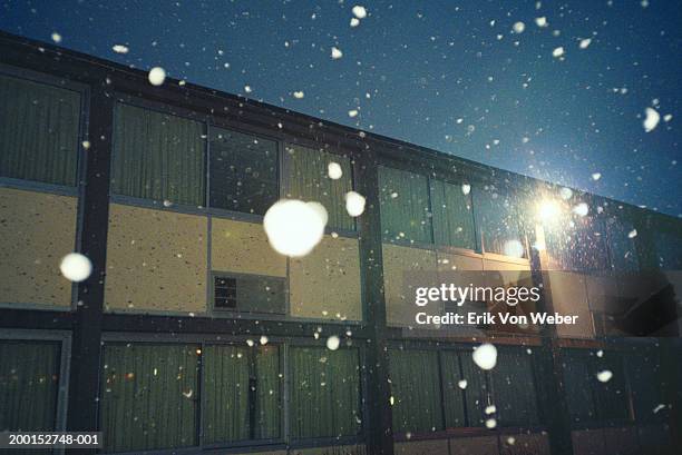 snow falling outside of motel, night, close-up - motel stock pictures, royalty-free photos & images