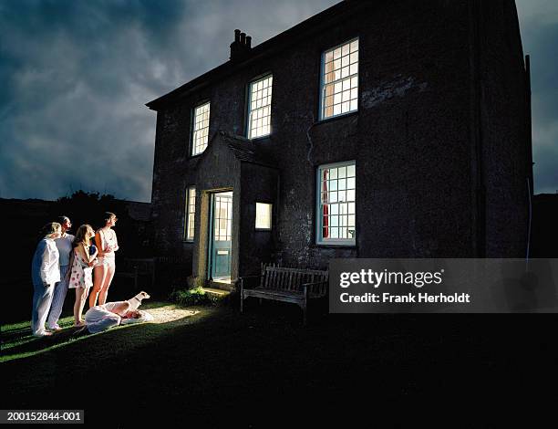 group of young women in nightware standing by backdoor, night - creepy house at night stock-fotos und bilder