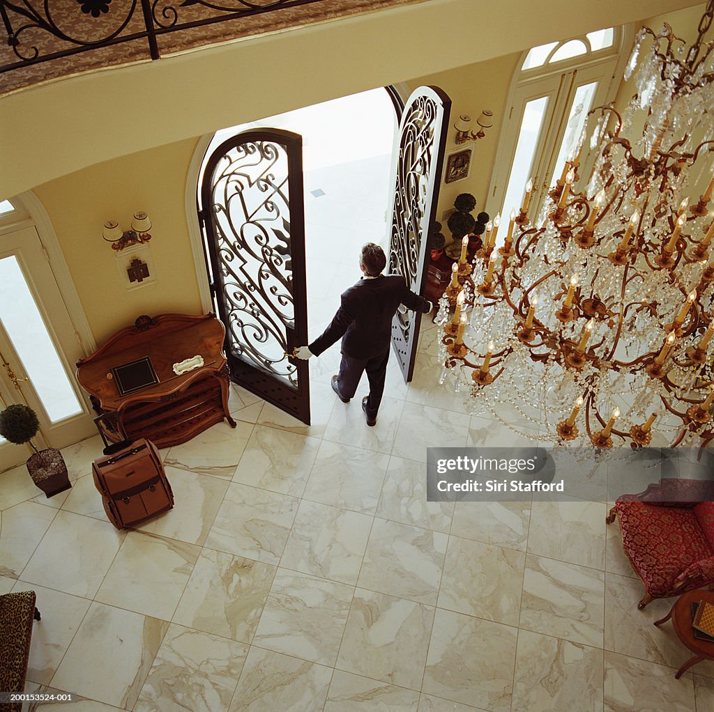Hotel attendant opening doors, elevated view