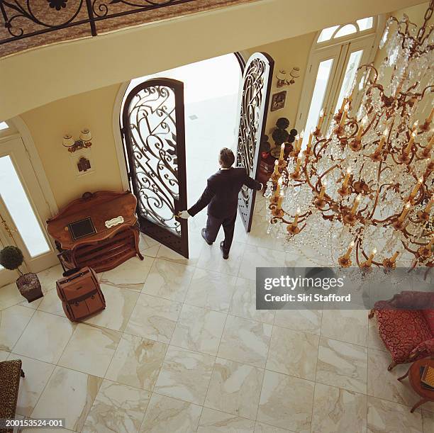 hotel attendant opening doors, elevated view - door attendant imagens e fotografias de stock