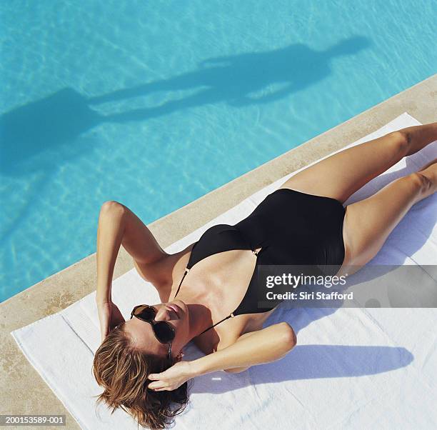 woman lying by side of pool, elevated view - swim suit stock pictures, royalty-free photos & images