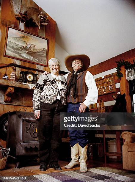senior couple laughing in living room, portrait - hunting trophy stock-fotos und bilder