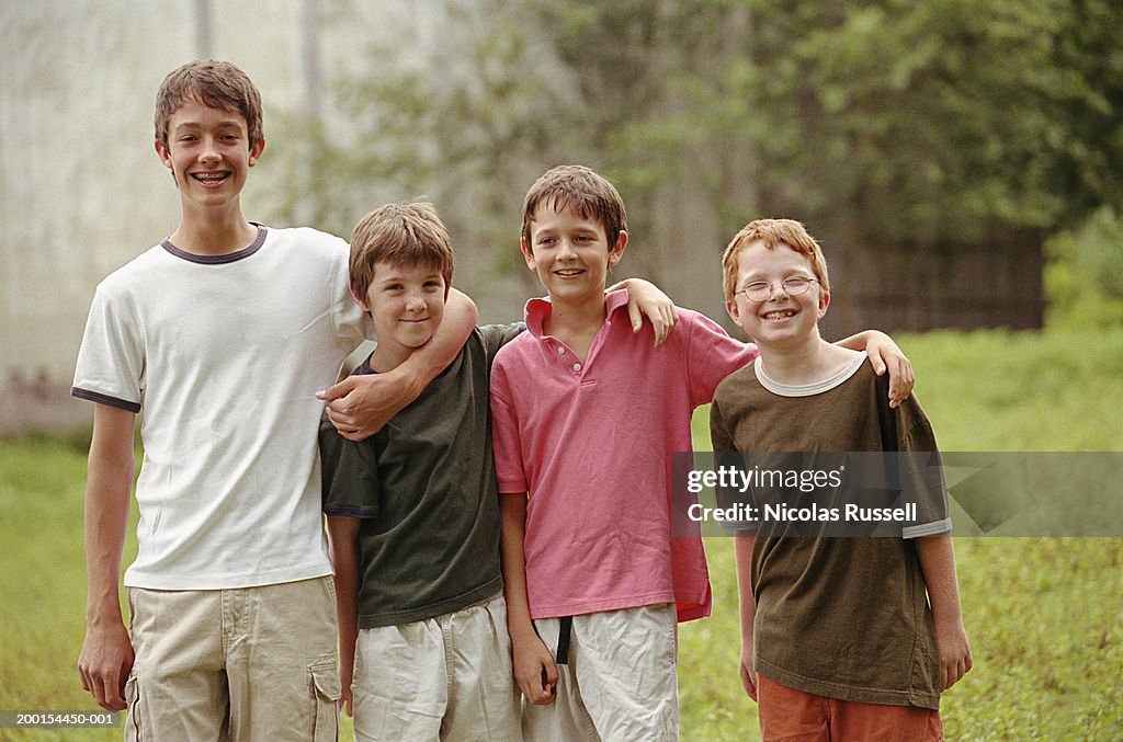 Four boys (10-15), smiling, portrait