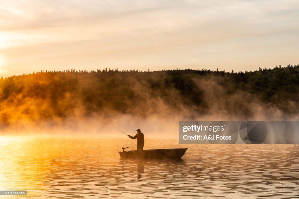 A senior man fishing at sunrise.