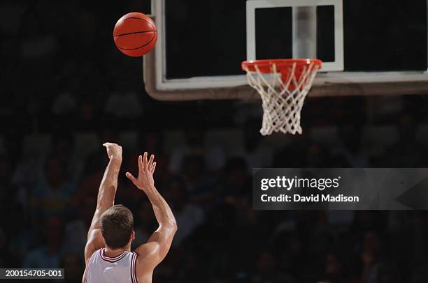 basketball player shooting from free throw line, rear view - basketball stockfoto's en -beelden