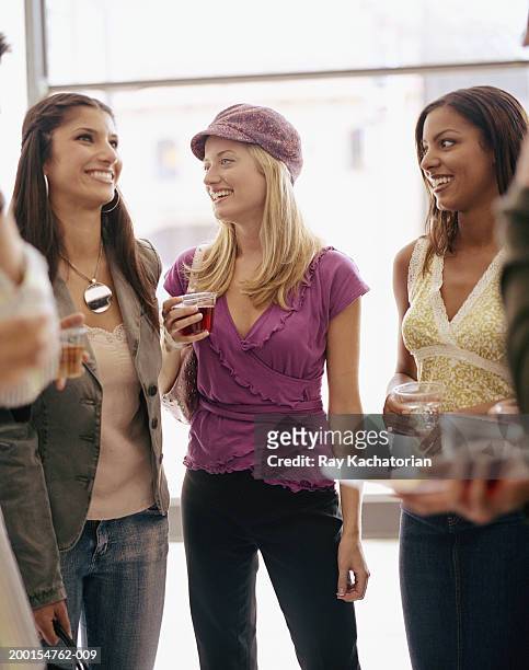 three young women in art gallery opening - art gallery opening stock pictures, royalty-free photos & images