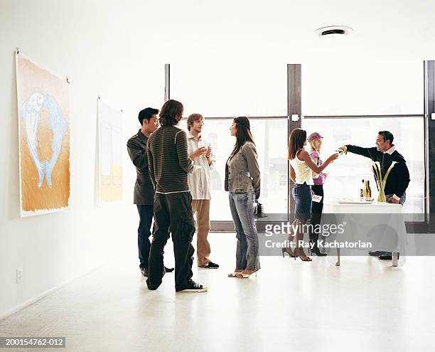 young adults attending art gallery reception - expo stockfoto's en -beelden