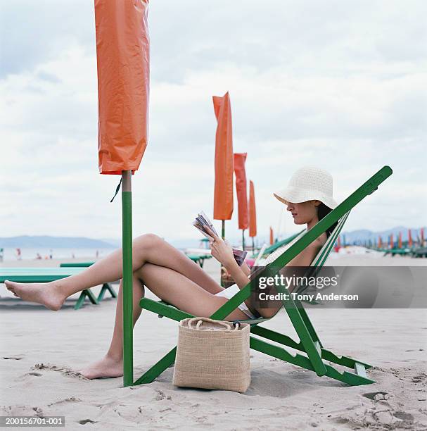 woman reading book at beach, side view - travel11 stock pictures, royalty-free photos & images